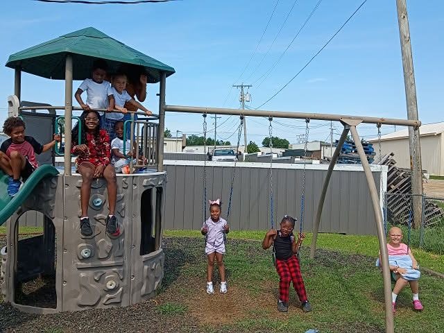 kids playing on the playground and swings