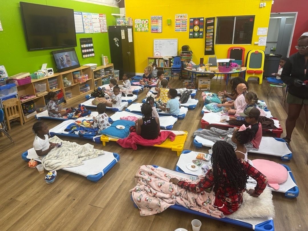 children relaxing on cots during rest time